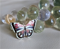 Vintage 1970s Gold Tone Butterfly Brooch with Red Blue and Yellow Enamel Application Vintage 1970s Gold Tone Butterfly Brooch with Red Blue and Yellow Enamel Application